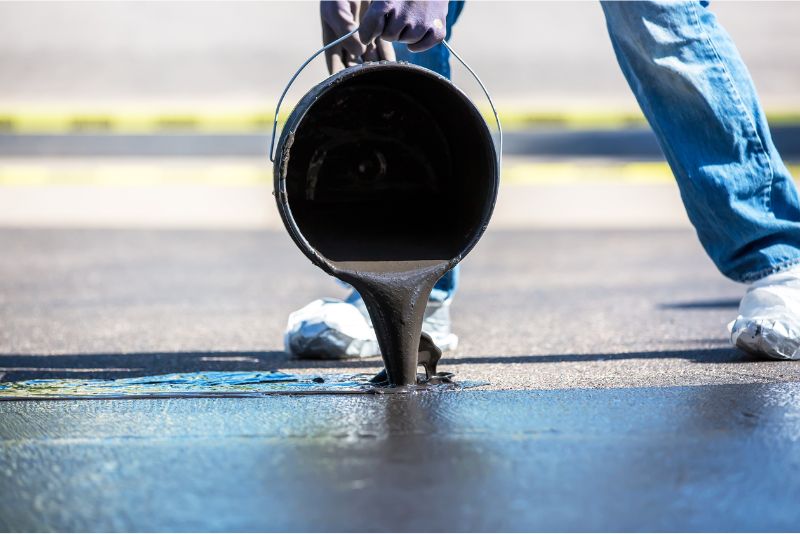 Epoxy resin being poured onto a concrete floor during installation