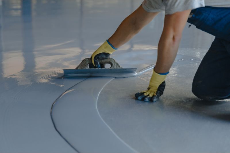 Epoxy coating being applied to a prepared concrete floor